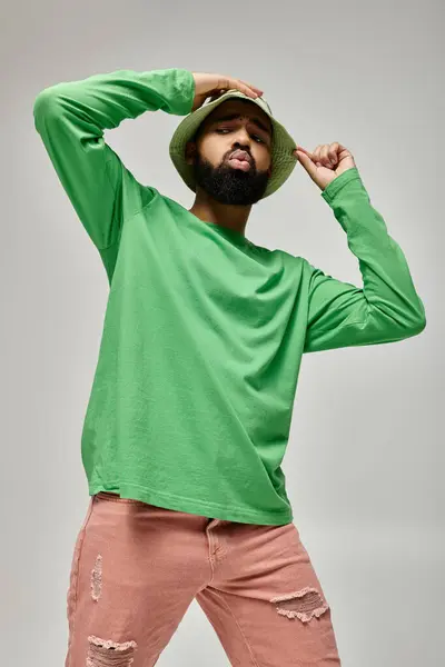 Handsome African American man posing in fashionable attire on vibrant backdrop. — Stock Photo