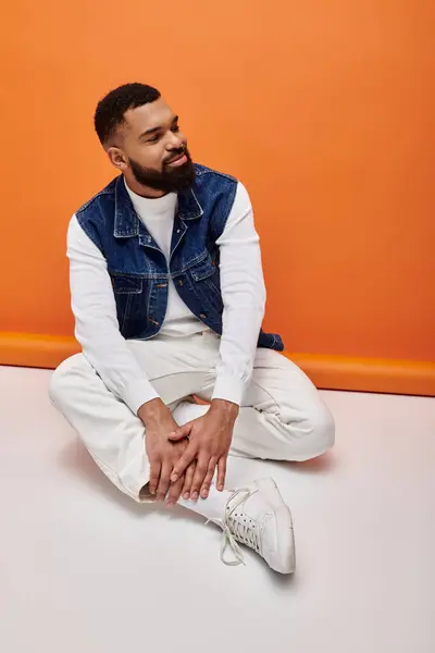 Stylish African American man sitting indoors. — Stock Photo