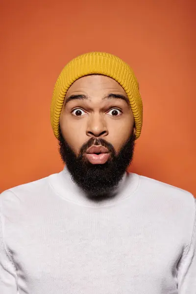 A stylish African American man sporting a beard and a yellow hat. — Stock Photo