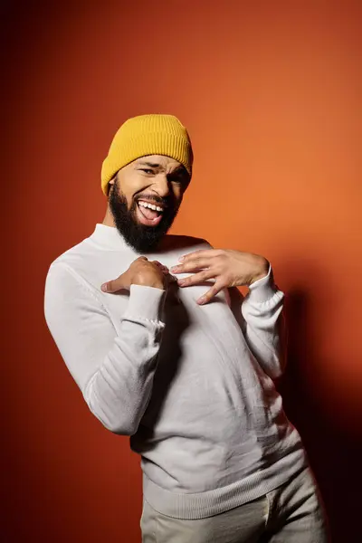 Stylish African American male with beard donning a yellow hat on colorful background. — Stock Photo