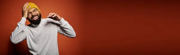 Handsome African American man in fashionable attire poses against vibrant backdrop. — Stock Photo