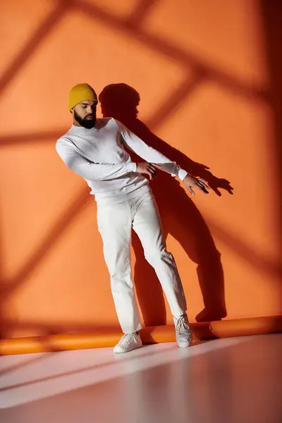 Handsome African American man poses in trendy white suit and yellow helmet against vibrant backdrop. — Stock Photo