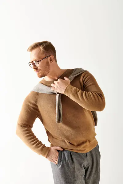 Handsome man in glasses and sweater striking a pose. — Stock Photo