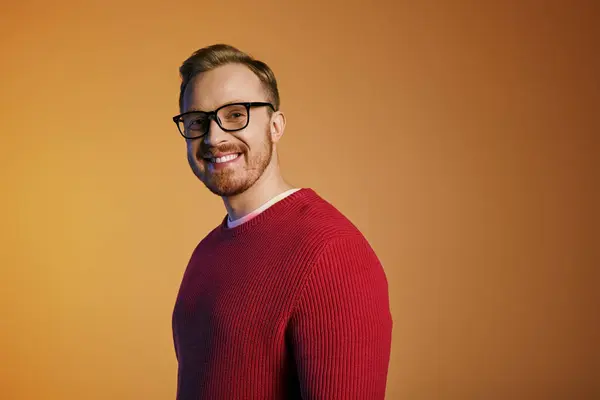 Handsome man wears fashionable red sweater and trendy glasses. — Stock Photo