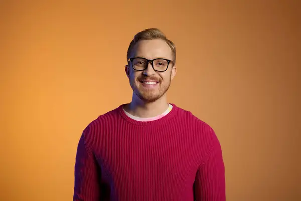 Handsome man in glasses and red sweater strikes a stylish pose. — Stock Photo