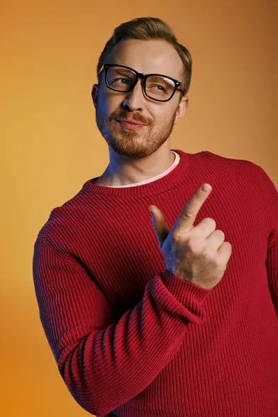 Stylish man in red sweater actively poses with gestures. — Stock Photo