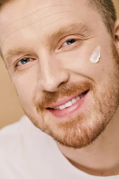 A close-up of a man applying cream. — Stock Photo