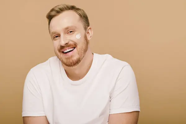 Handsome man in white shirt performing skincare routine. — Stock Photo