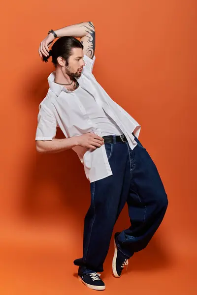Handsome Caucasian man in trendy white shirt and blue pants. — Stock Photo