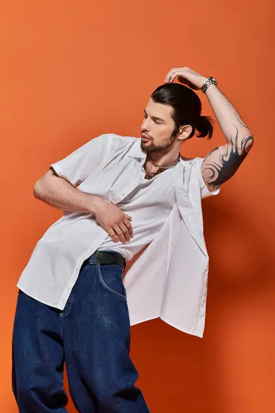 Handsome Caucasian man in trendy white shirt and blue jeans. — Stock Photo