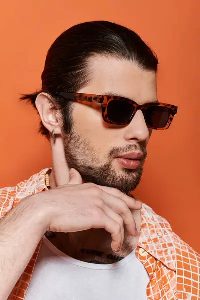 A caucasian man with a beard wearing sunglasses and a checkered shirt. — Stock Photo