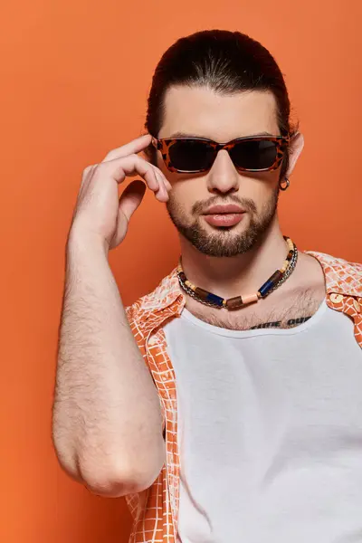 A fashionable caucasian man wearing sunglasses and a necklace. — Stock Photo