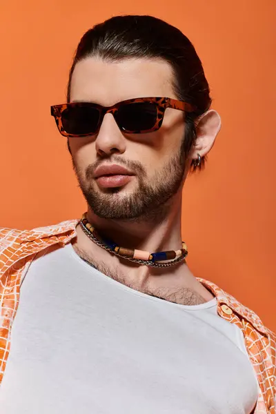 Handsome Caucasian man in trendy attire wearing sunglasses and a necklace. — Stock Photo