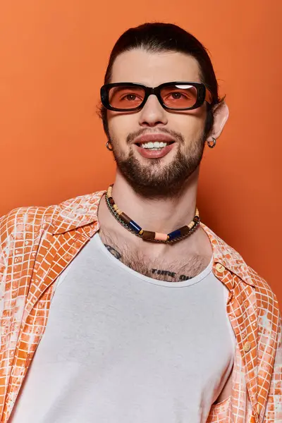 Caucasian man with beard and glasses wearing a necklace. — Stock Photo