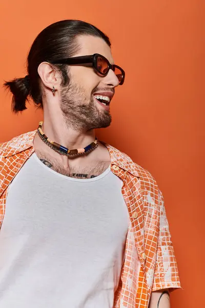 Trendy caucasian man with beard, sunglasses, and necklace. — Stock Photo