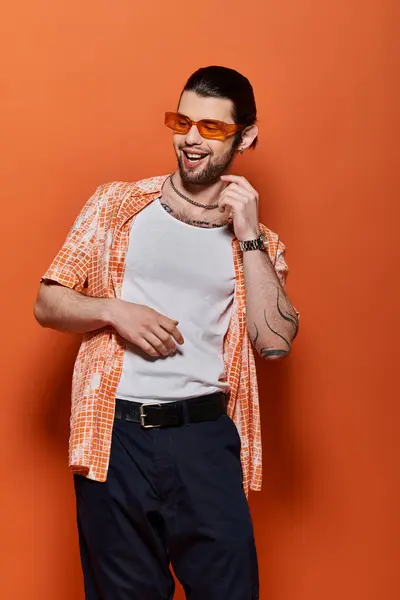 Handsome Caucasian man wearing trendy white t-shirt and orange cardigan. — Stock Photo