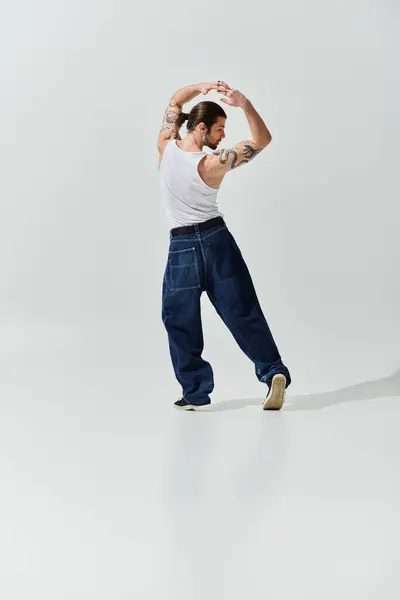 A handsome Caucasian man in trendy attire dancing freely and energetically. — Stock Photo