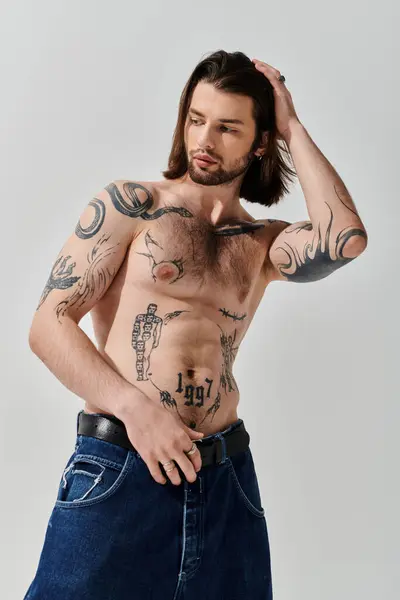Shirtless man displaying intricate chest tattoos. — Stock Photo