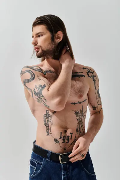 Shirtless caucasian man flaunting chest tattoos. — Stock Photo