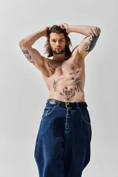 Handsome Caucasian man proudly displays chest tattoos. — Stock Photo