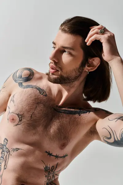 Shirtless man flaunting tattooed chest. — Stock Photo