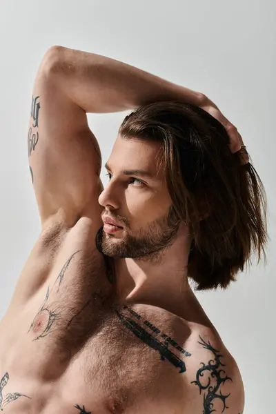 Shirtless man flaunting chest tattoos. — Stock Photo