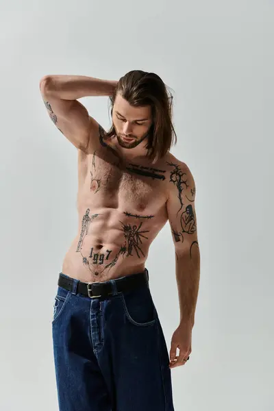 Stylish caucasian man showcasing long hair and chest tattoos. — Stock Photo