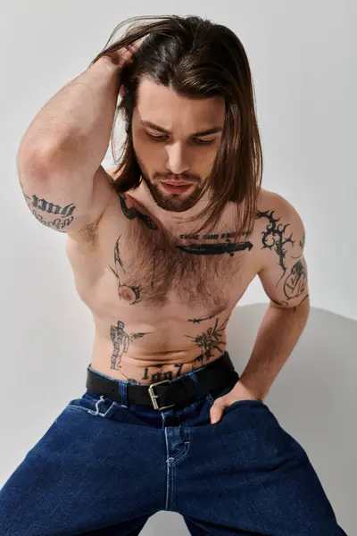 Handsome Caucasian man with long hair and chest tattoos. — Stock Photo