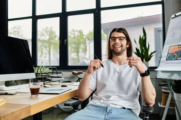 A man focused at his desk, working on a computer. — Stock Photo