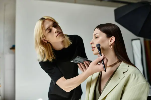 A woman receiving professional makeup application from a skilled artist. — Stock Photo