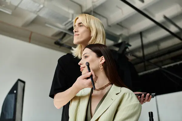 A professional stylist applying makeup on womans face. — Stock Photo