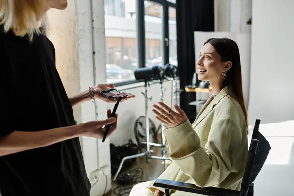 Talented professional stylist applying makeup on womans face. — Stock Photo