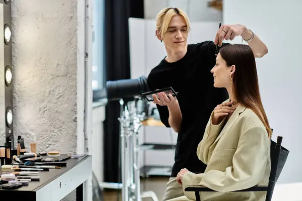 A skilled makeup artist beautifying a womans face in a luxurious salon. — Stock Photo
