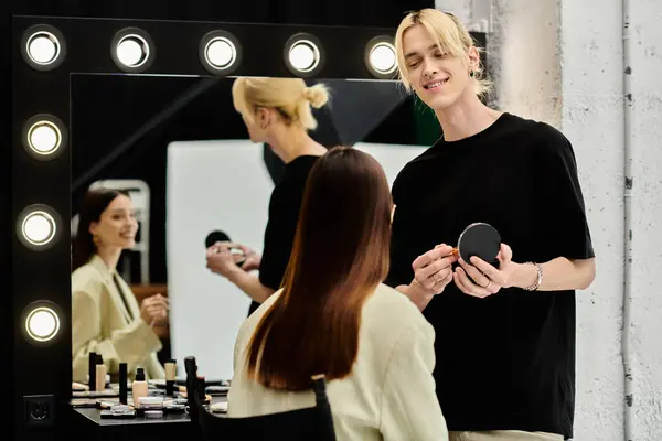 Talented stylist applying makeup on womans face. — Stock Photo