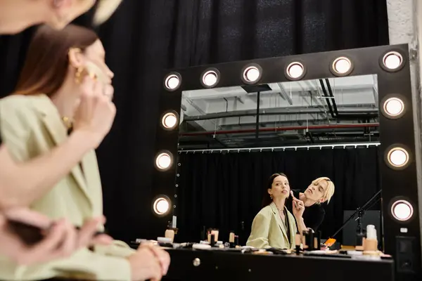 Young woman enjoying makeup session with stylist. — Stock Photo