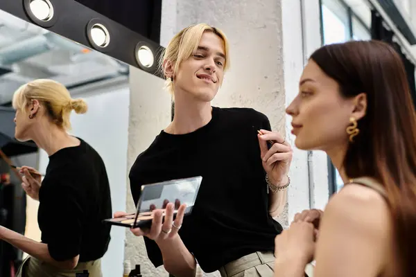 Long haired woman enjoying makeup session with stylist. — Stock Photo