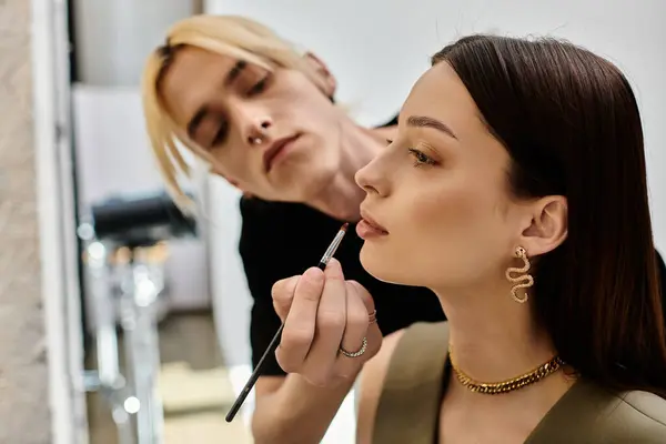 A woman receives a professional makeup application from another woman. — Stock Photo