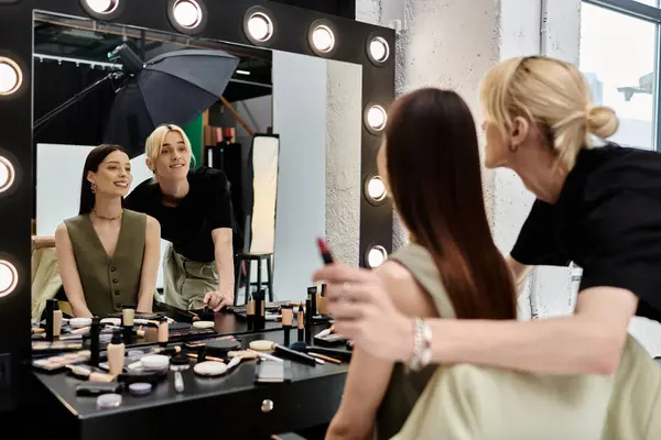 Woman admiring herself in mirror, next to her stylist. — Stock Photo