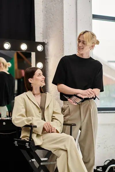 Young lgbtq makeup artist stands near his client. — Stock Photo