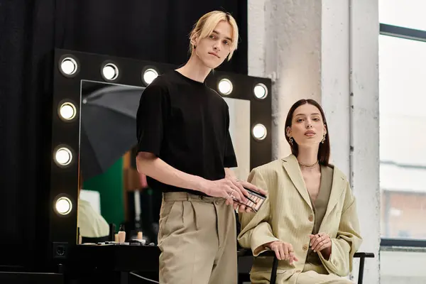 Talented lgbtq makeup artist stands near his client. — Stock Photo