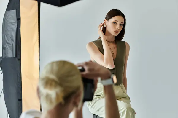 Young man taking photos of young woman on camera. — Stock Photo