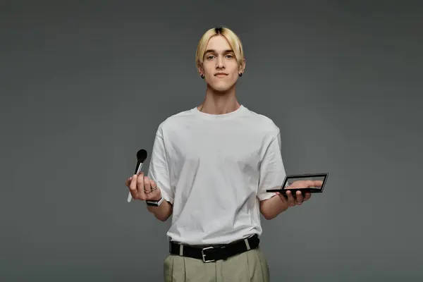 Stylish man multitasking with a palette of makeup. — Stock Photo