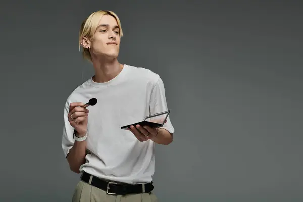 Handsome man multitasking with a palette of makeup. — Stock Photo