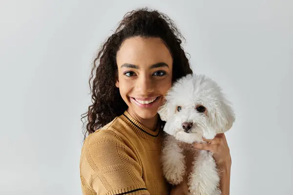 Woman peacefully holding her white dog in a loving embrace. — Stock Photo