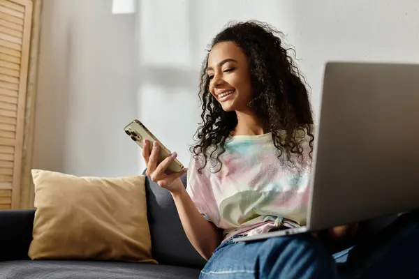 Young woman using laptop on couch. — Stock Photo