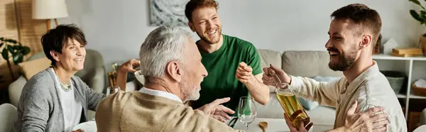 A gay couple is embraced by parents during a heartwarming family gathering. — Stock Photo