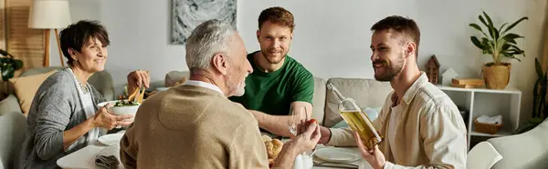 A gay couple introduces their partner to parents at home during a family gathering. — Stock Photo