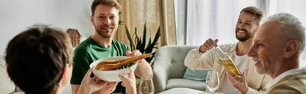 A gay couple is welcomed by their family at home during a celebratory dinner. — Stock Photo