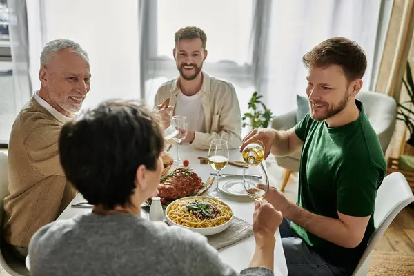 A gay couple enjoys a meal with parents at home. — Stock Photo