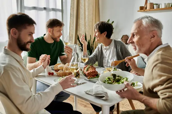 A gay couple enjoys a meal with parents at home. — Stock Photo